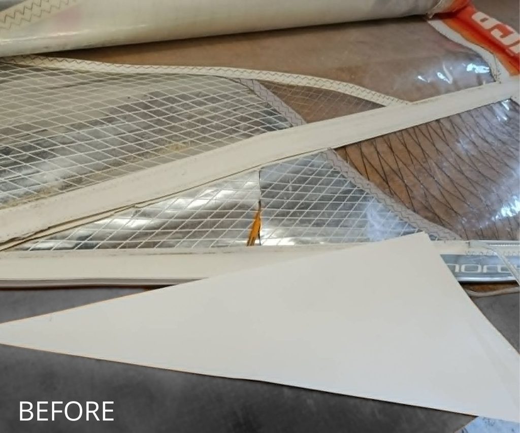 Damaged windsurf sail before window repair